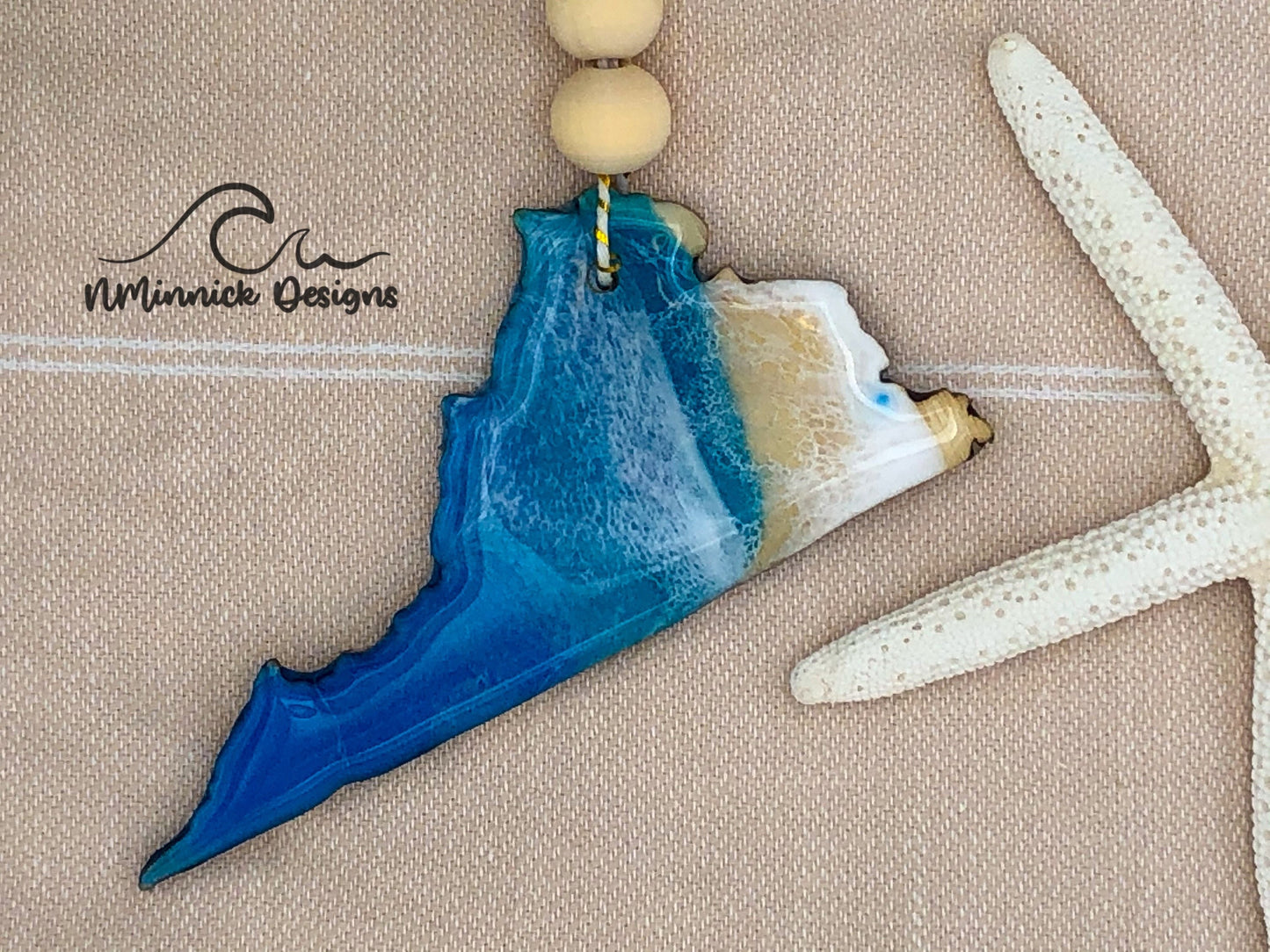 Virginia shaped beach scene ornament, approximately 4 inches.  Colors are dark ocean blue and okinawa blue with white waves made of epoxy resin. Finished with bakers twine and two wooden beads.