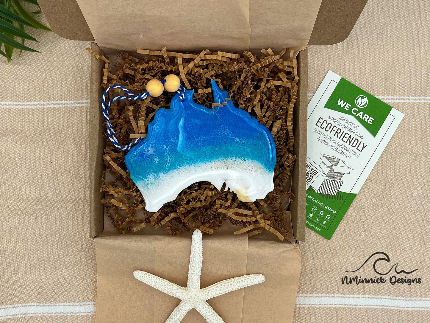 Australia Ornament with ocean resin waves finished with two wooden beads and blue and white twine