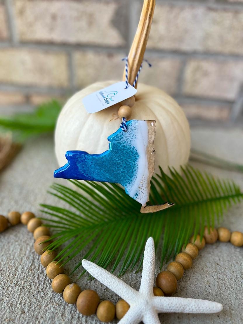 Handmade New York ocean resin ornament resting on a white pumpkin, coastal design inspired by Long Island beaches and ocean waves