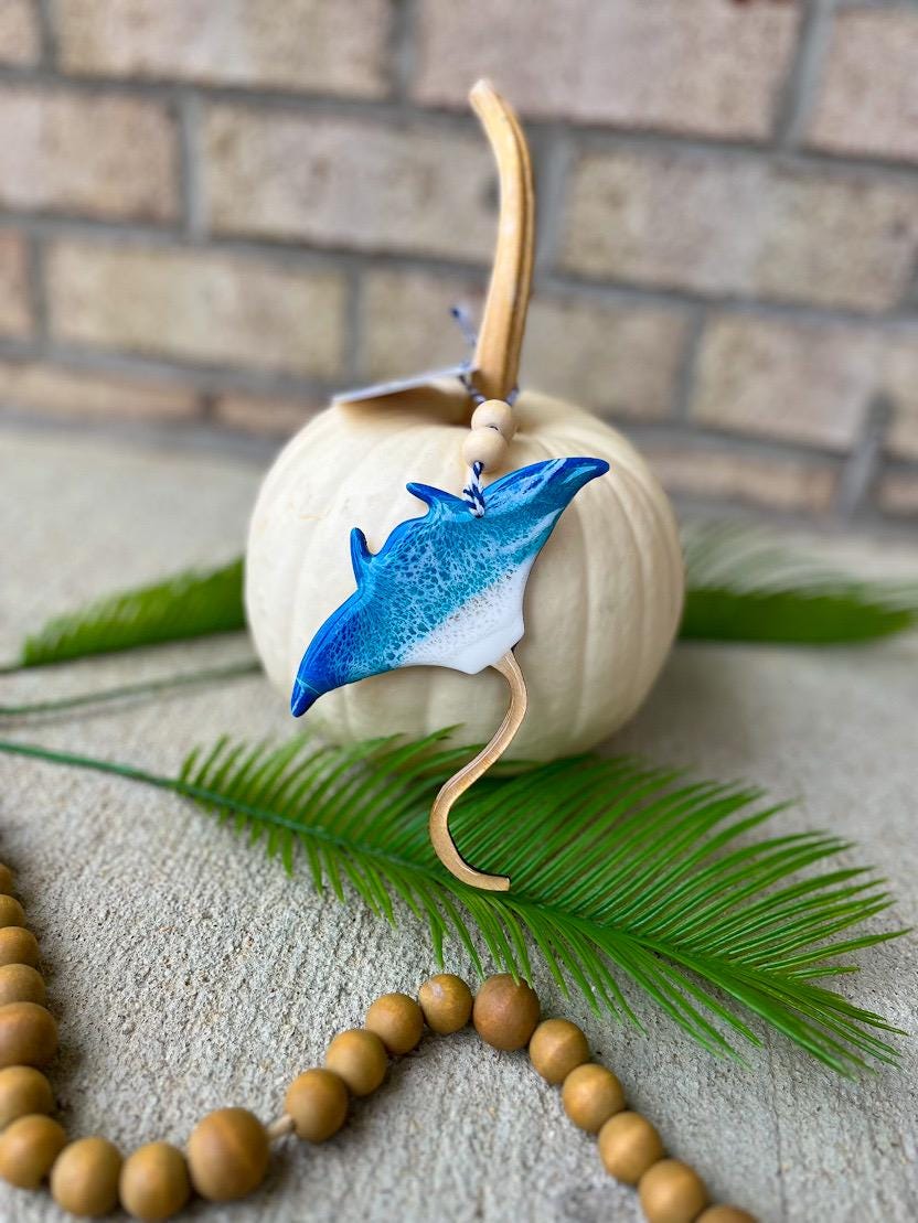 Coastal manta ray ornament with ocean resin waves displayed on a white pumpkin, handcrafted beach-inspired decoration
