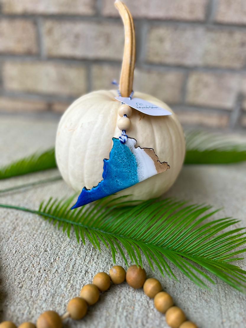 Handmade Virginia ocean resin ornament resting on a white pumpkin, coastal design inspired by Virginia beach and ocean waves