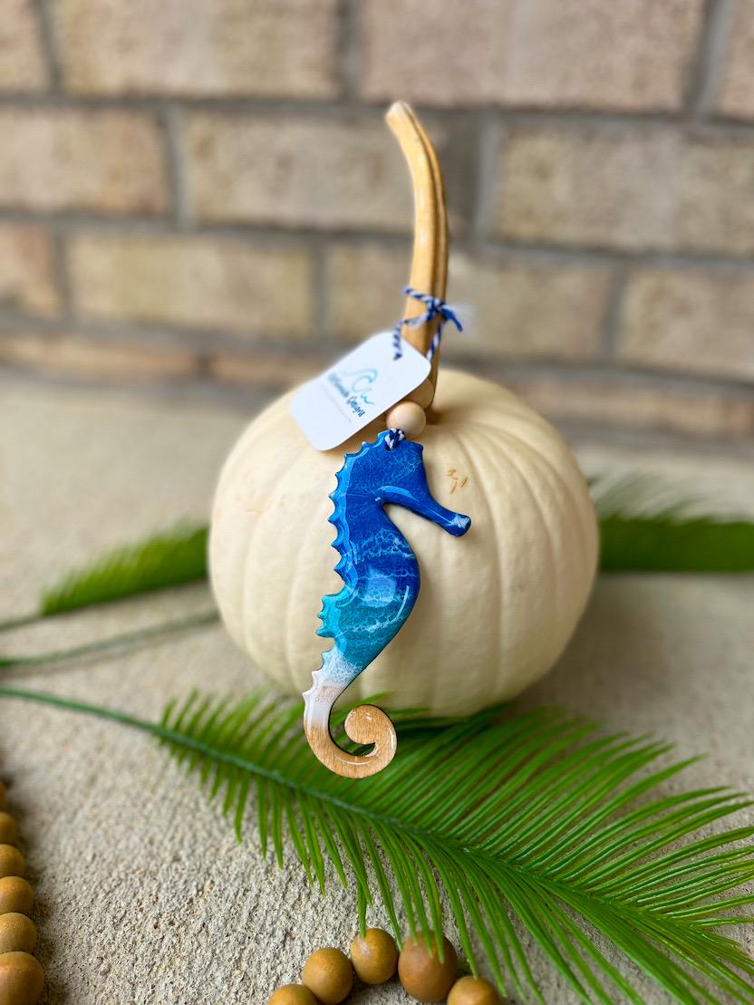 Coastal seahorse ornament with ocean resin waves displayed on a white pumpkin, handcrafted beach-inspired decoration