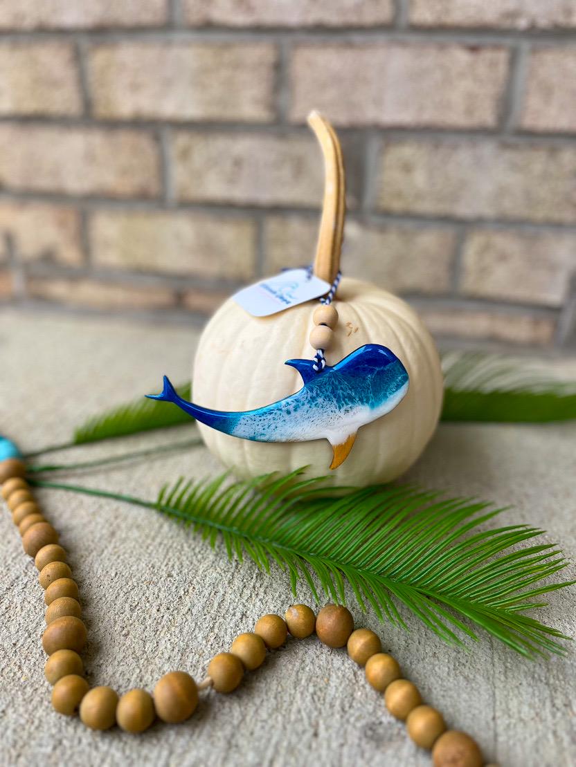 Coastal whale shark ornament with ocean resin waves displayed on a white pumpkin, handcrafted beach-inspired decoration