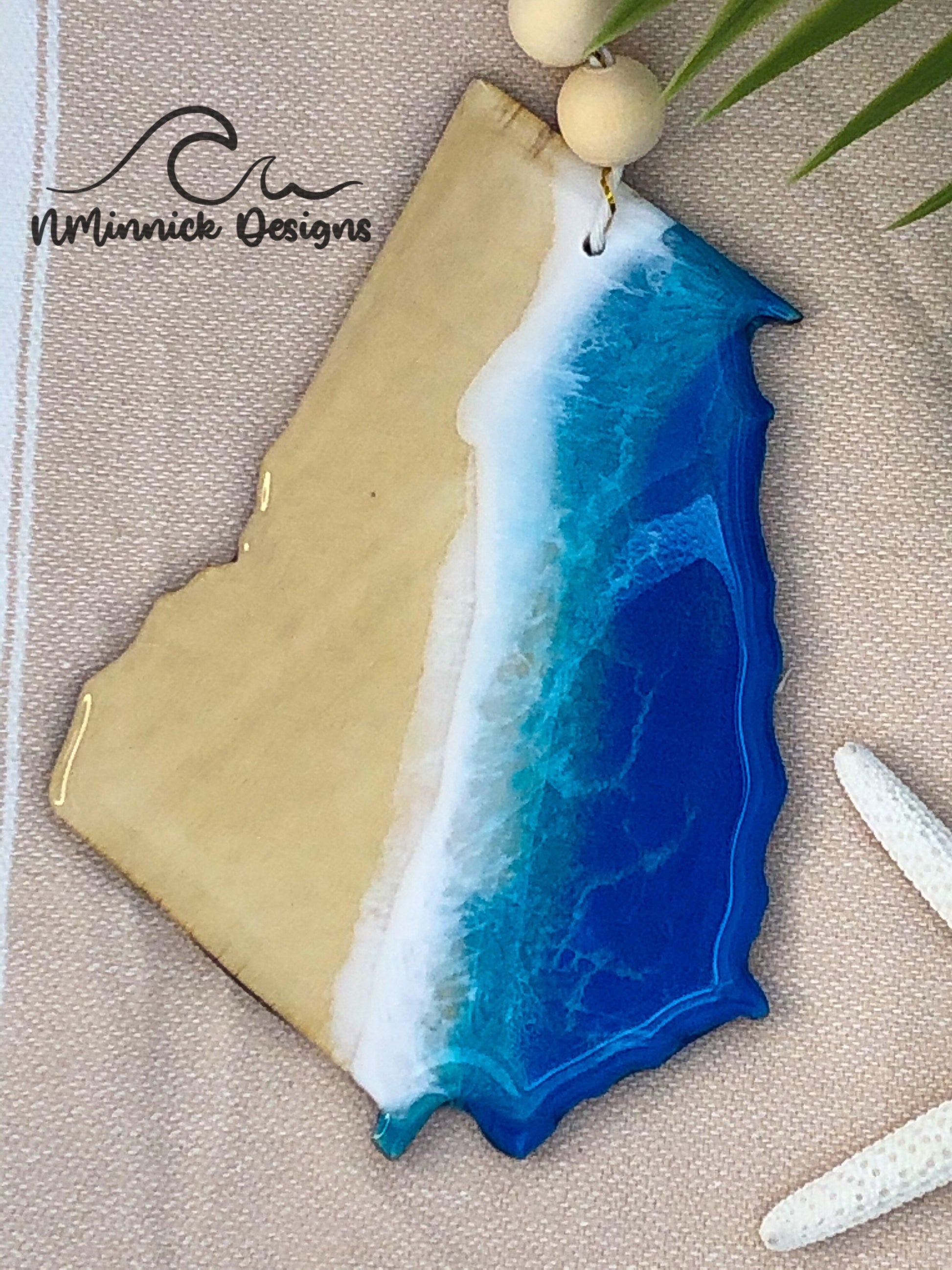 4.5 to 5 inch laser cut wood ornament in the shape of Georgia.  Coastal ocean scene created with epoxy resin and blue, teal, and white mica pigments.
