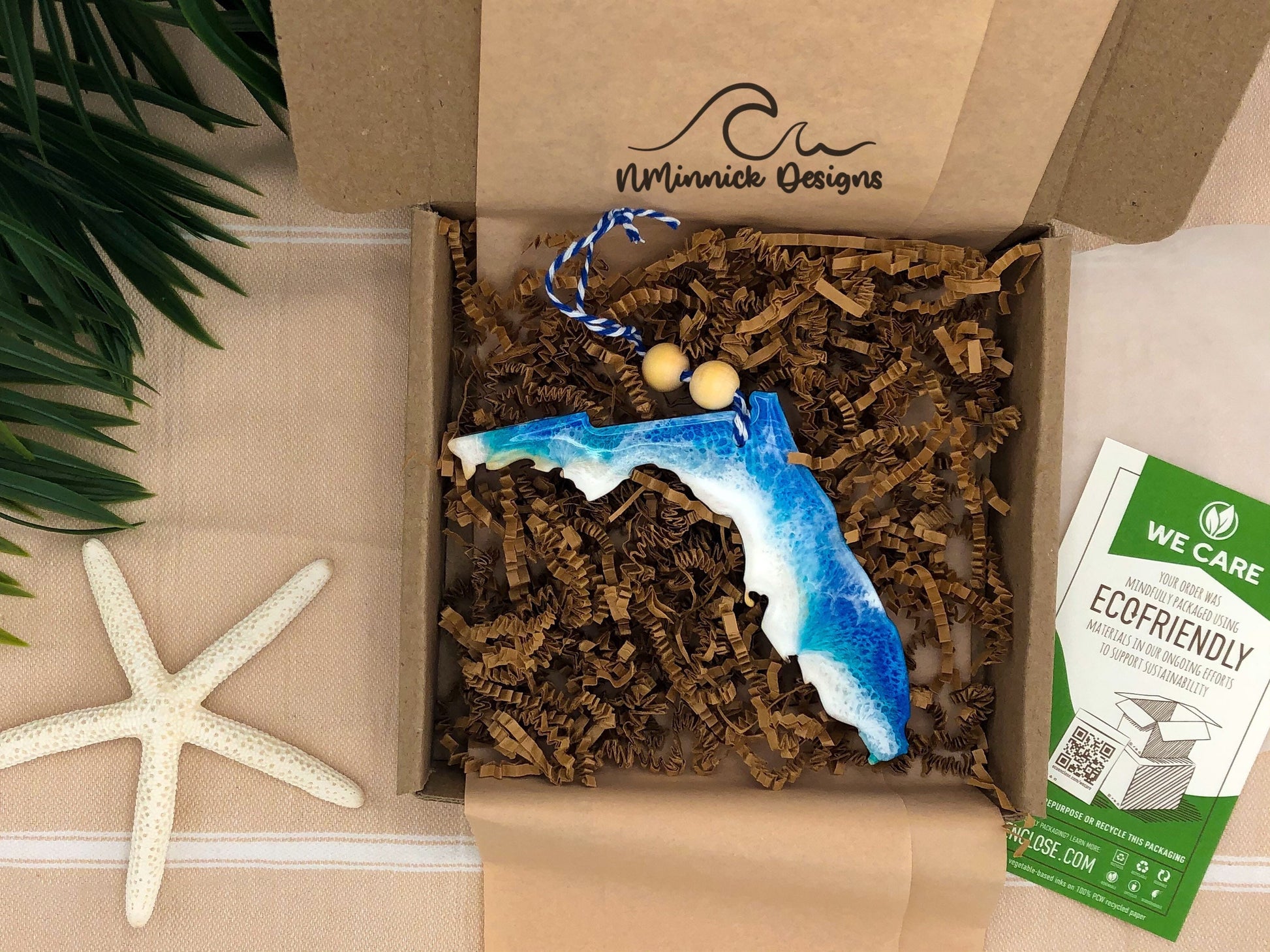 a florida ocean beach ornament with ocean waves on the atlantic side of the state packaged in ecofriendly plastic free materials with recyclable box, tissue paper and paper shred.