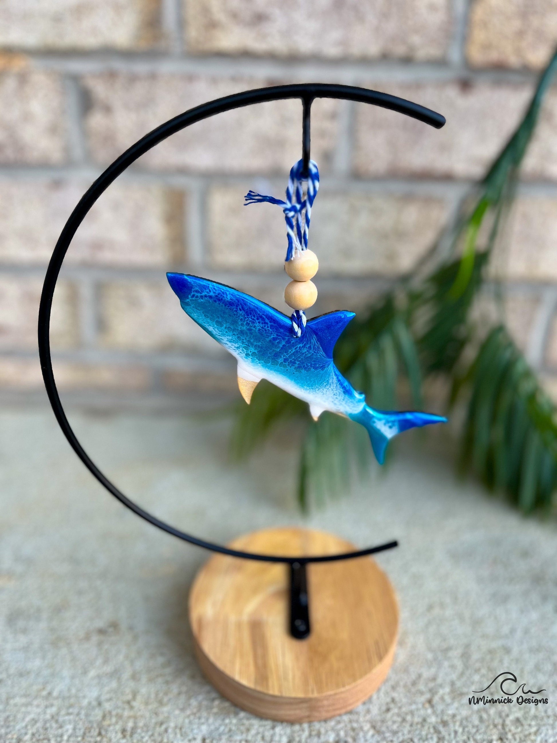 Galapagos shark ornament with ocean resin art hanging from an ornament stand.