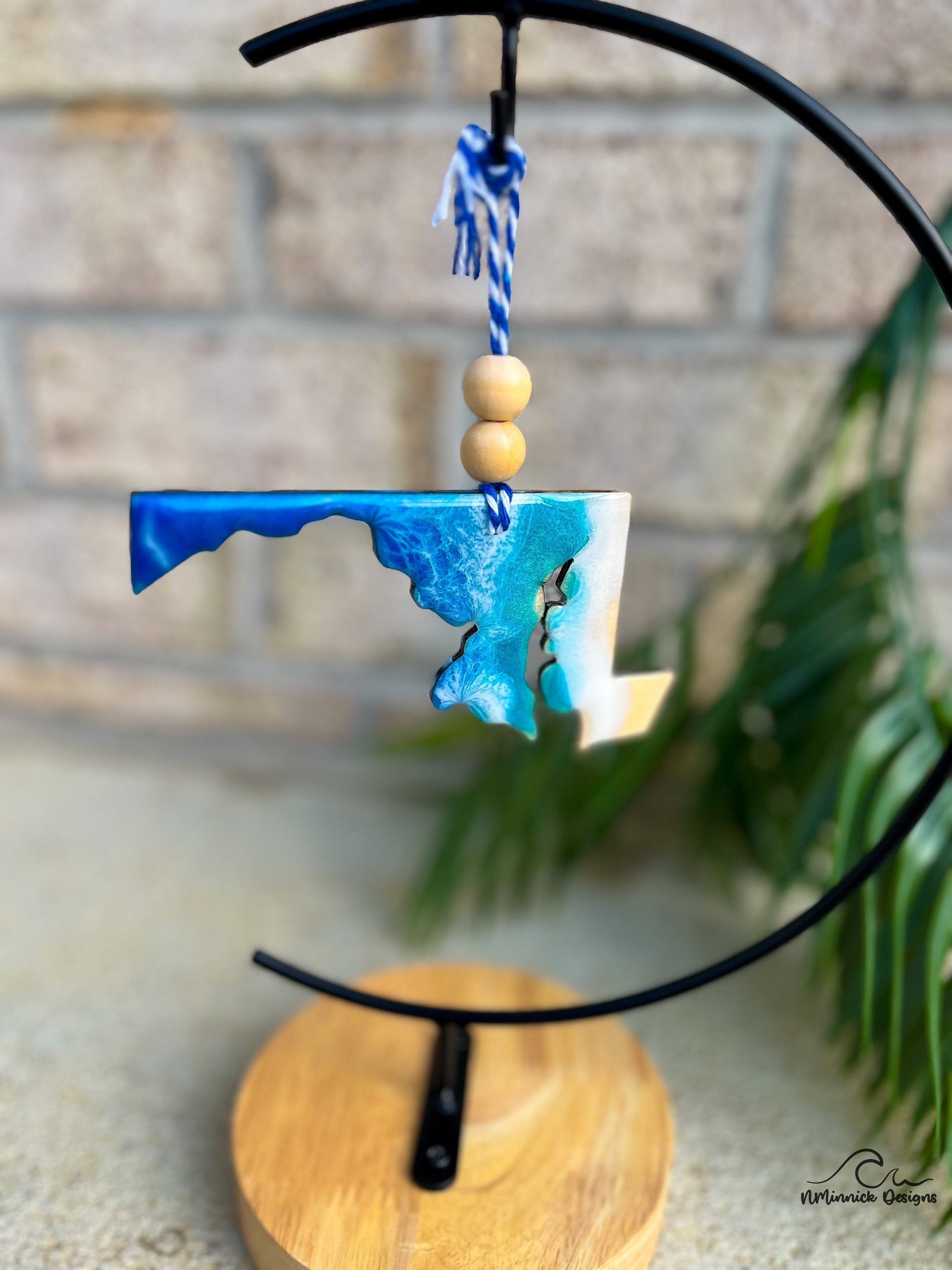 Maryland ornament with ocean resin art hanging on an ornament stand.
