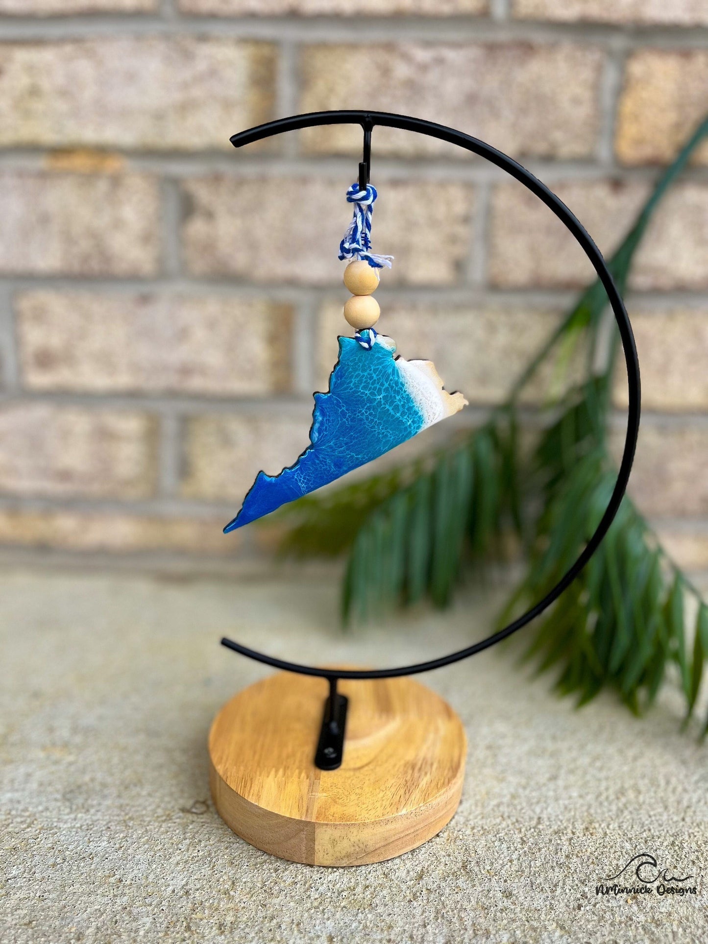Virginia state ornament with ocean resin art hanging from an ornament stand.