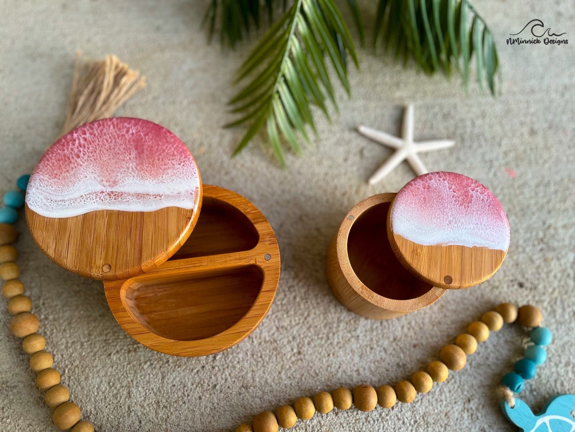 a single salt cellar and a dual salt and pepper cellar, both with magnetic closures and pink sunrise ocean resin art on the lids