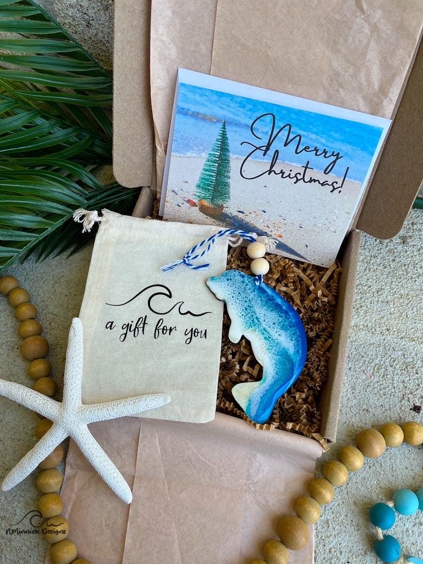 Manatee Ocean Wood and Resin Ornament complete with a muslin gift bag and a custom Merry Christmas card. Resin art on the ornament is blue and teal with waves to mimic those on the coast of Florida.