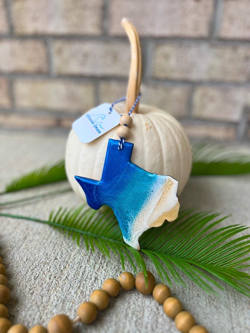 Handmade Texas ocean resin ornament resting on a white pumpkin, coastal design inspired by Galveston, South Padre Island, and Mustang Island beaches