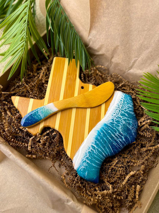 Texas state-shaped bamboo charcuterie board and cheese spreader featuring ocean resin art, eco-conscious packaging, beach-inspired gift set
