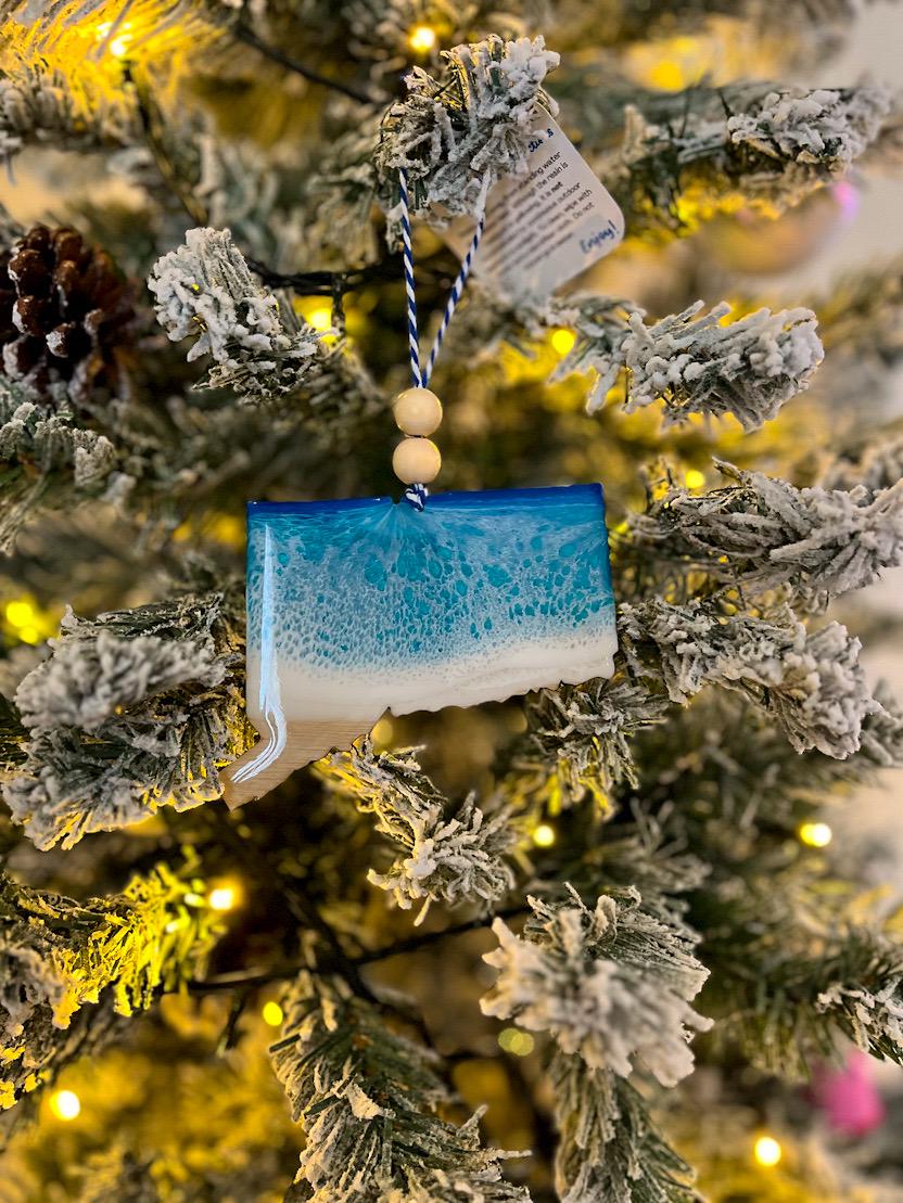 Handmade Connecticut shaped wooden ornament featuring ocean resin waves, finished with blue and white twine and two natural wooden beads