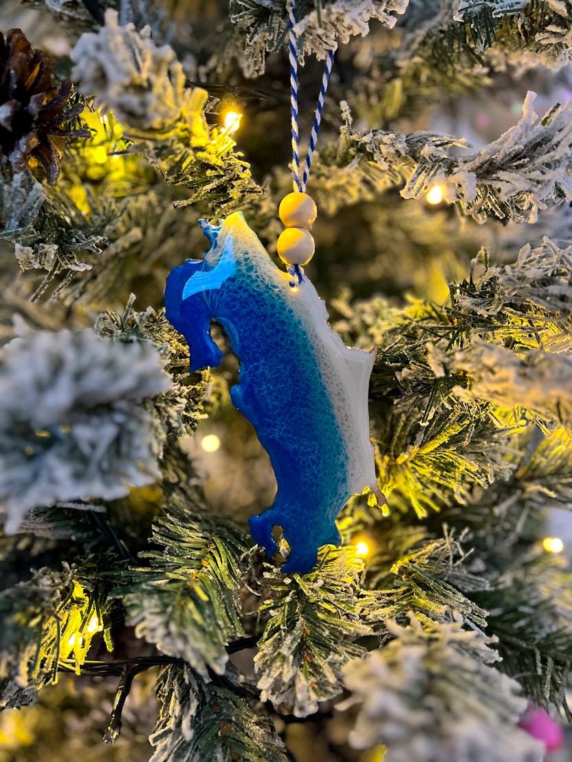 Handmade Costa Rica shaped wooden ornament featuring ocean resin waves, finished with blue and white twine and two natural wooden beads