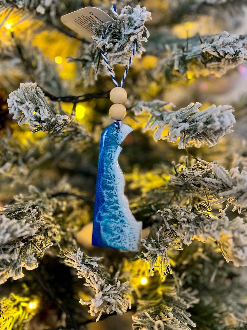 Handmade Delaware shaped wooden ornament featuring ocean resin waves, finished with blue and white twine and two natural wooden beads