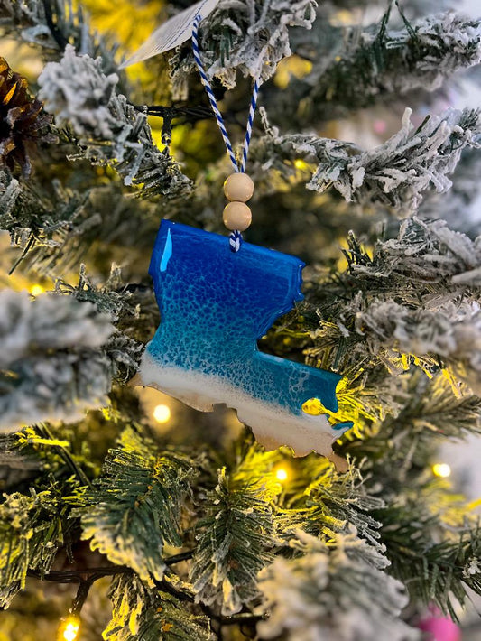 Handmade Louisiana shaped wooden ornament featuring ocean resin waves, finished with blue and white twine and two natural wooden beads