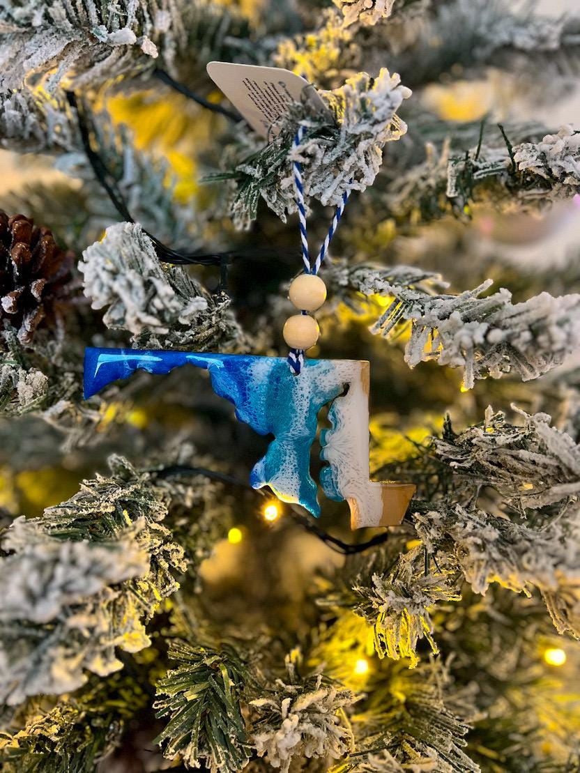 Handmade Maryland shaped wooden ornament featuring ocean resin waves, finished with blue and white twine and two natural wooden beads