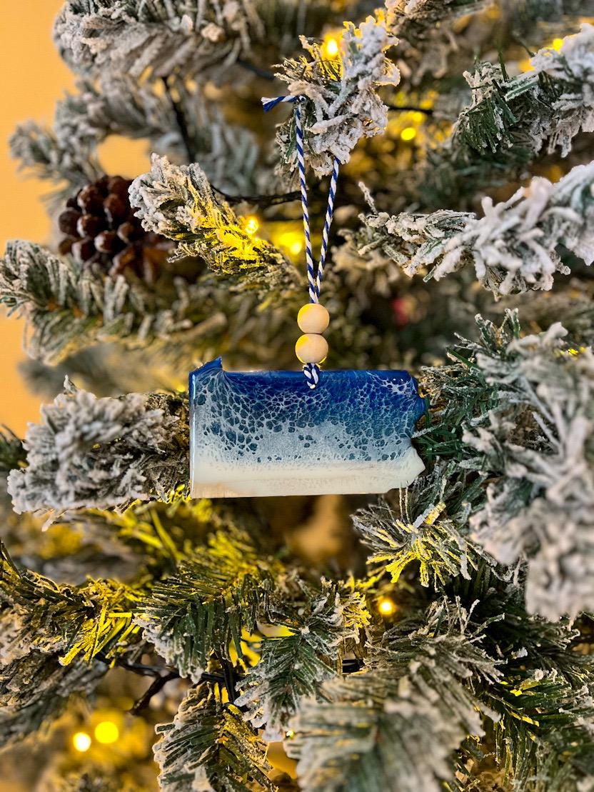 Handmade Pennsylvania shaped wooden ornament featuring resin waves, finished with blue and white twine and two natural wooden beads