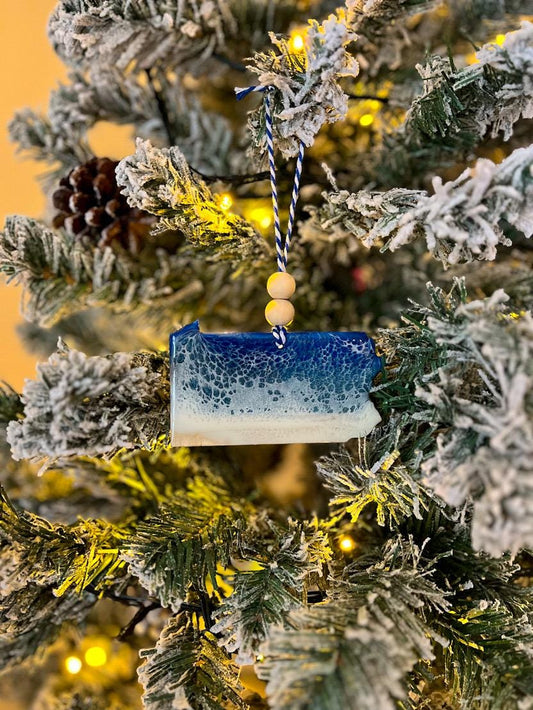Handmade Pennsylvania shaped wooden ornament featuring resin waves, finished with blue and white twine and two natural wooden beads