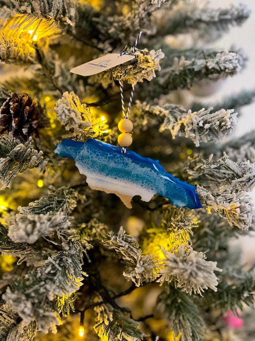 Handmade Jamaica shaped wooden ornament featuring ocean resin waves, finished with blue and white twine and two natural wooden beads