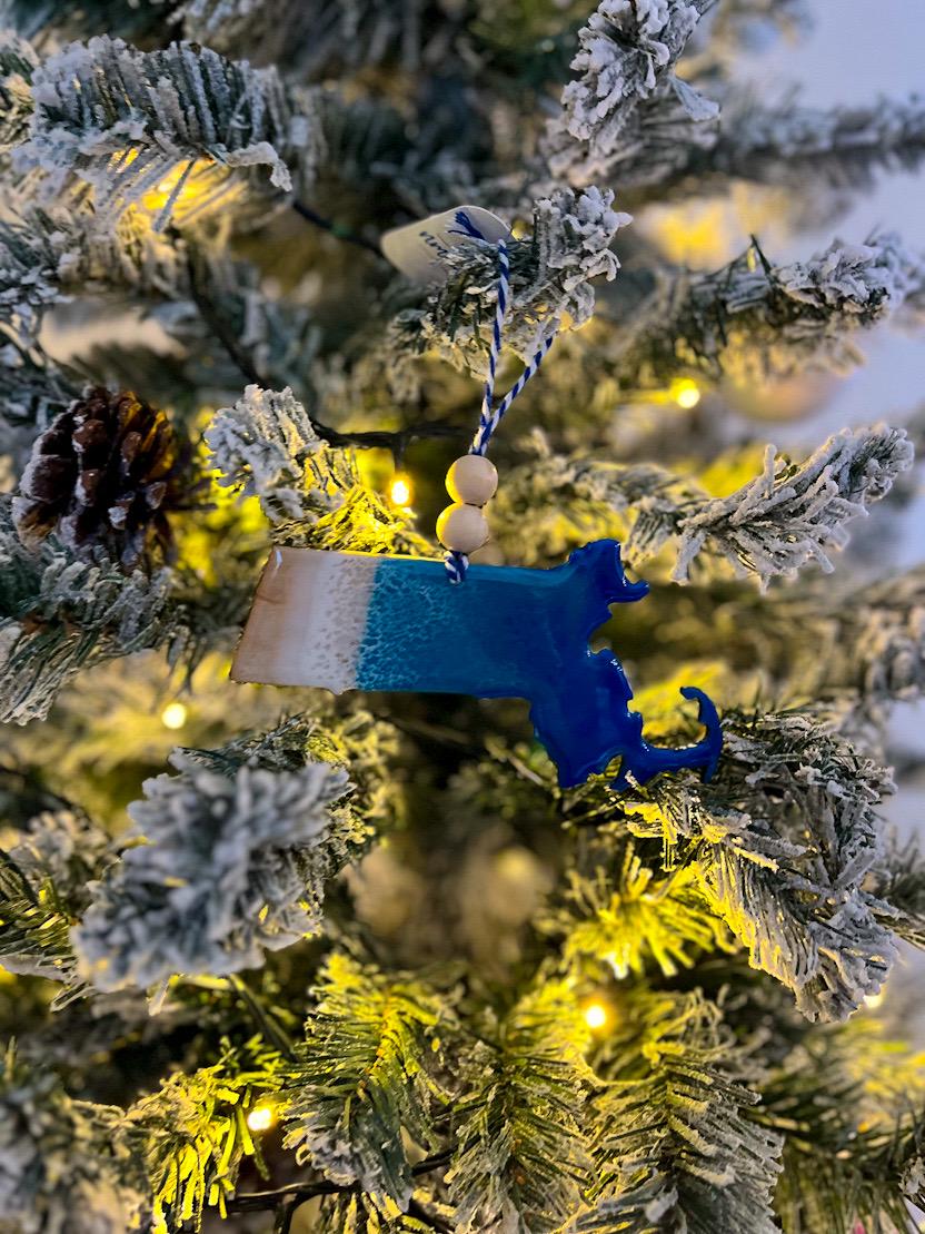 Handmade Massachusetts shaped wooden ornament featuring ocean resin waves, finished with blue and white twine and two natural wooden beads