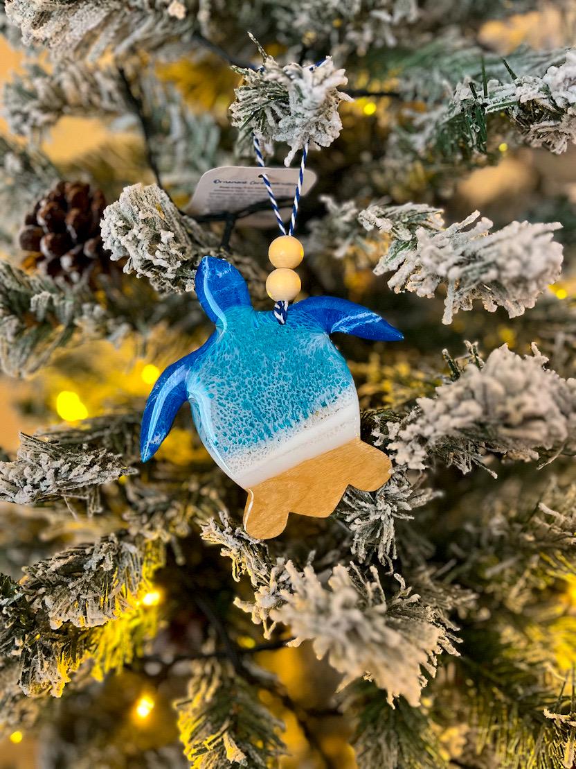 Handmade Sea Turtle shaped wooden ornament featuring ocean resin waves, finished with blue and white twine and two natural wooden beads