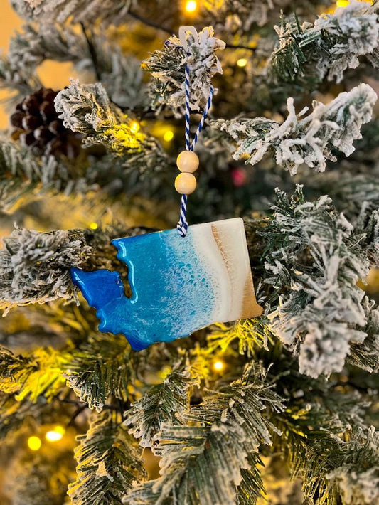 Handmade Washington State shaped wooden ornament featuring ocean resin waves, finished with blue and white twine and two natural wooden beads