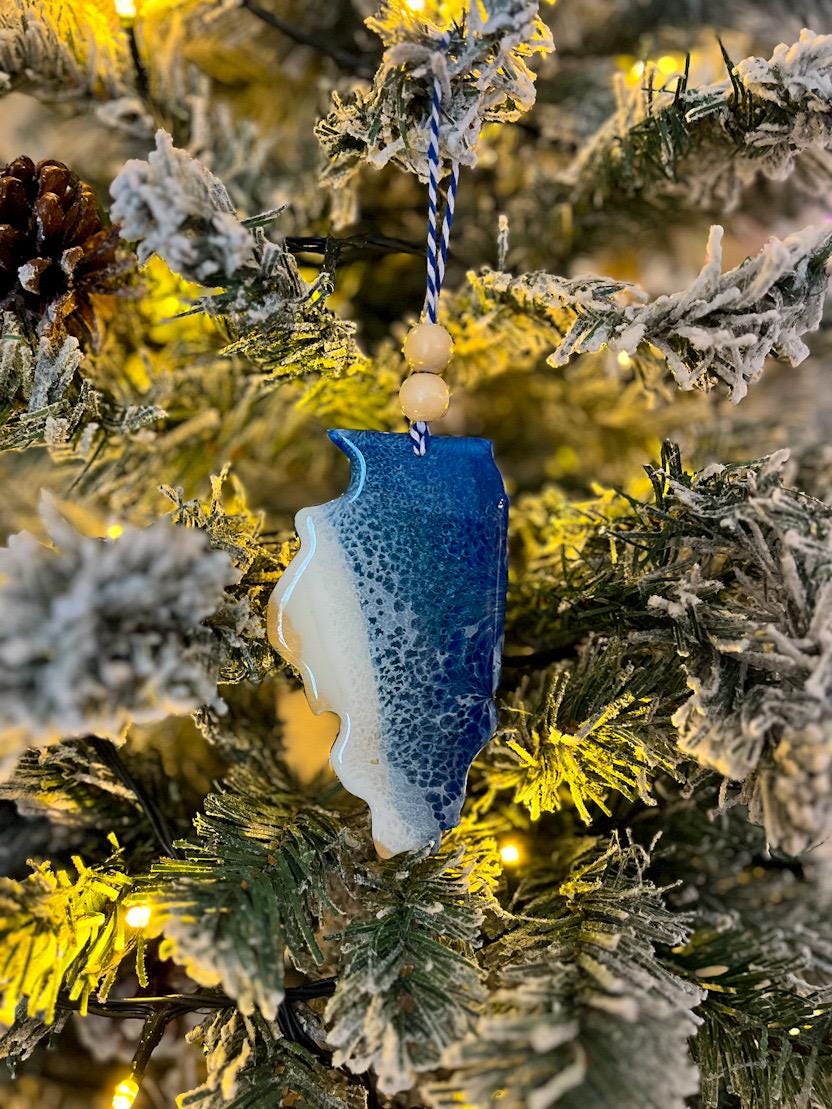 Handmade Illinois shaped wooden ornament featuring resin waves, finished with blue and white twine and two natural wooden beads