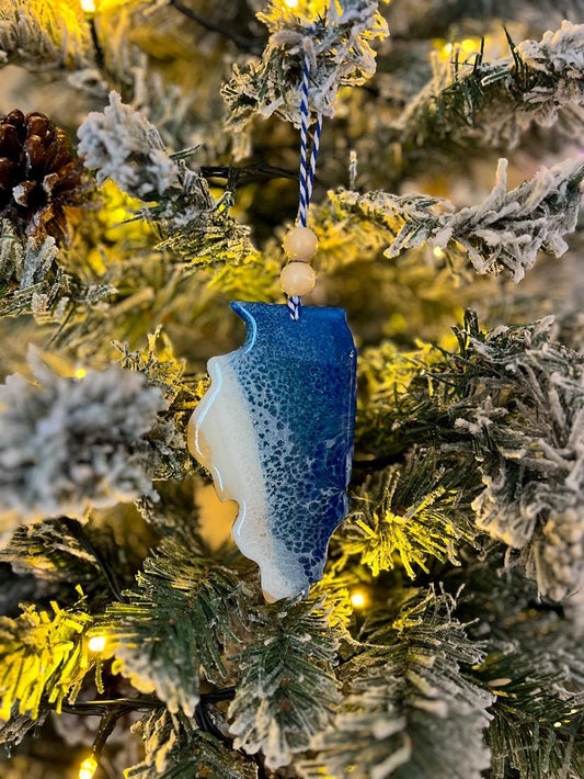 Handmade Illinois shaped wooden ornament featuring resin waves, finished with blue and white twine and two natural wooden beads