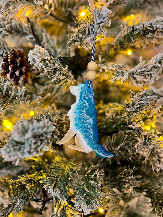 Handmade Dog shaped wooden ornament featuring ocean resin waves, finished with blue and white twine and two natural wooden beads