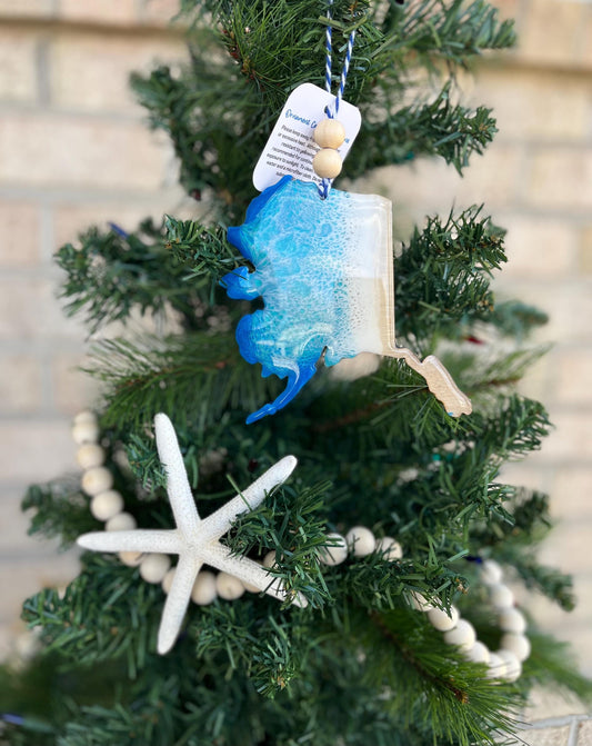 Alaska Ornament featuring ocean resin art and finished with two wooden beads and blue and white twine.
