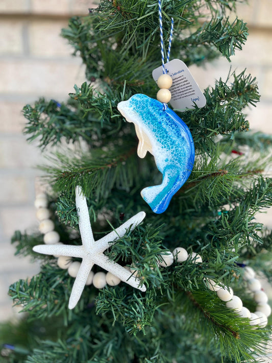 Manatee ornament with ocean resin waves and finished with two wooden beads and blue and white twine