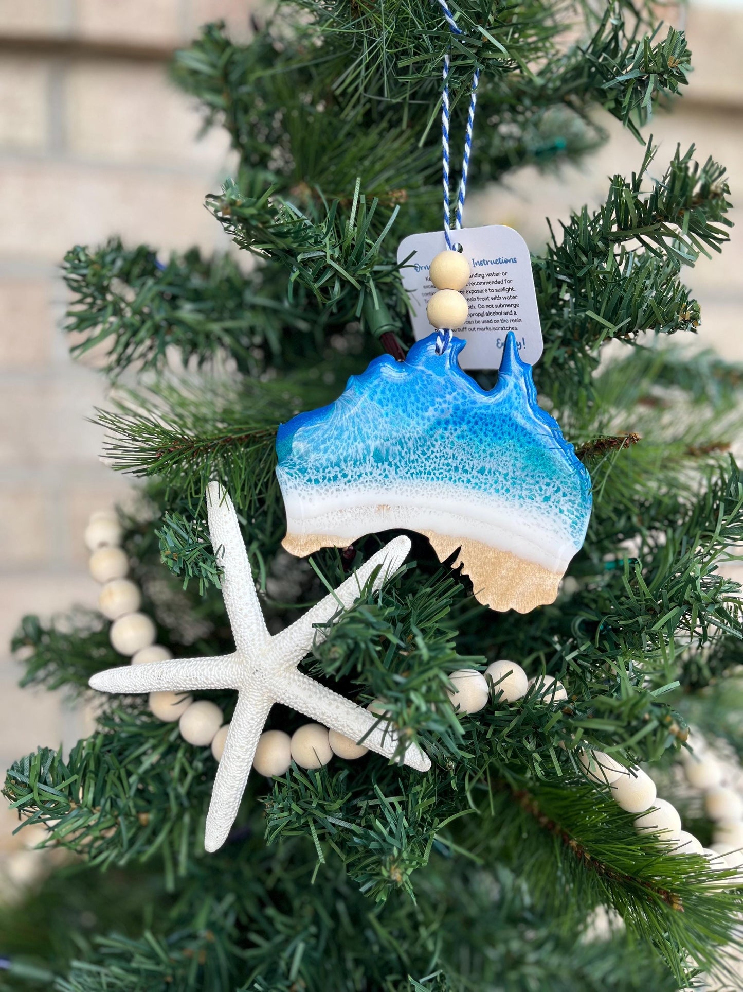 Australia Ornament with ocean resin waves finished with two wooden beads and blue and white twine