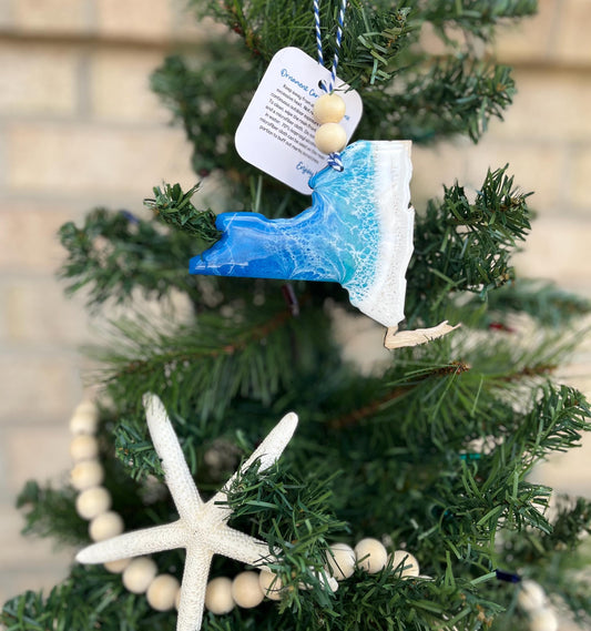 New York ornament with ocean resin art and finished with two wooden beads and blue and white twine. Hanging on a Christmas tree with a wooden garland and starfish.