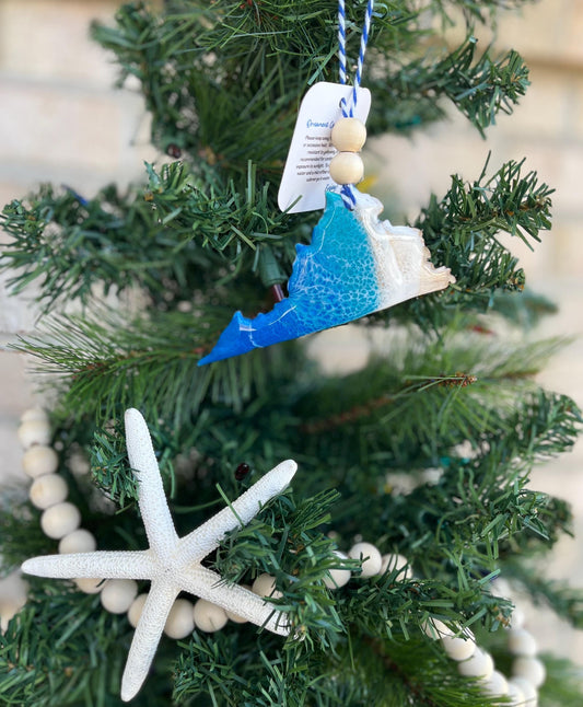 Virginia ornament featuring ocean resin waves and finished with two wooden beads and blue and white twine. Hanging on a christmas tree with a wooden bead garland and a starfish.