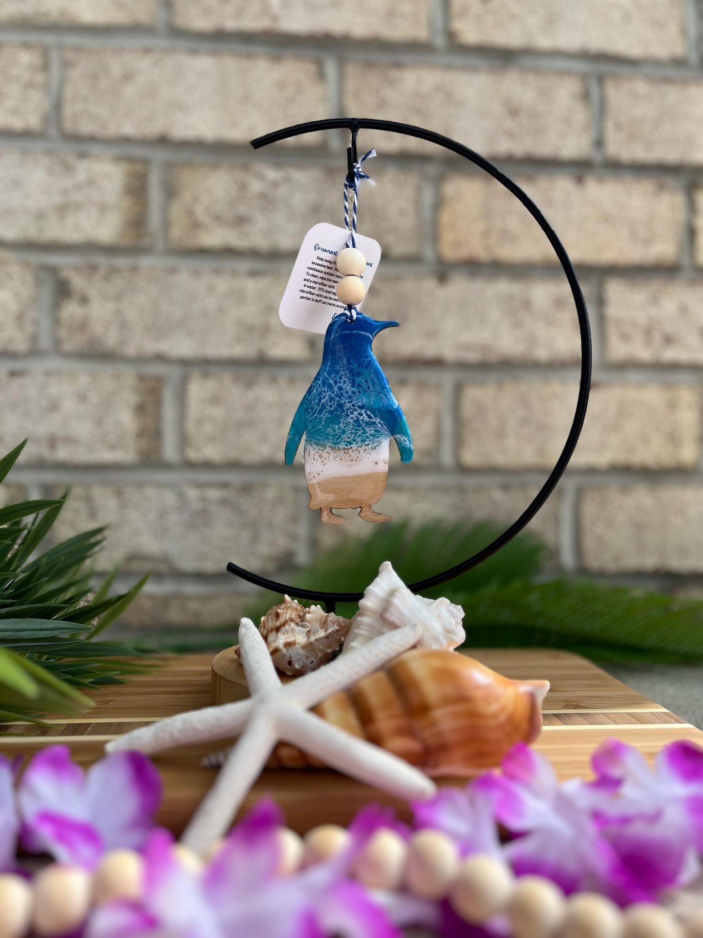 Penguin Ocean Resin Ornament hanging on an ornament hook