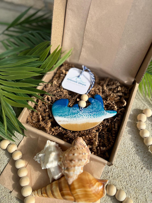 Sea Otter Ornament laying in an ecofriendly gift box