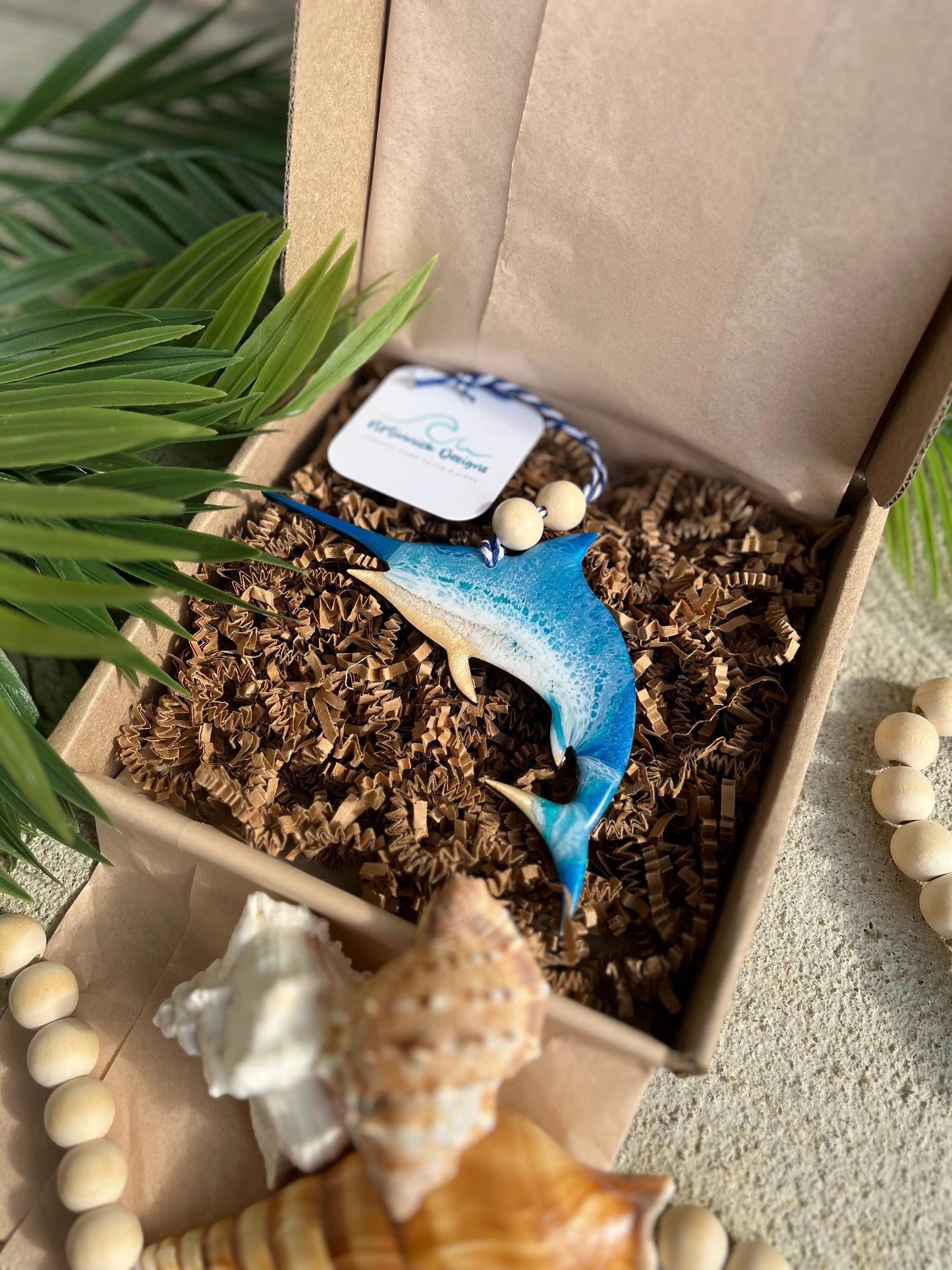 Marlin Ocean Ornament laying in an ecofriendly gift box